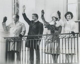 Prime Minister Pierre Trudeau and President Jimmy Carter, with their wives, Margaret and Rosalynn, wave yesterday from a balcony of the White House