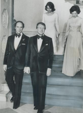 On way to a white house dinner last night are Prime Minister Pierre Trudeau and President Jimmy Carter with wives