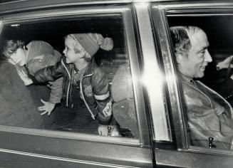 Former Liberal Leader Pierre Trudeau arrives home late 11/21 with seven-year-old son Justin(L) and five-year-old son Michel(C) in the back seat of car