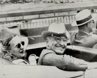 Home from 'Frisco, President Truman flashes his happy smile as he and daughter Margaret ride from the airport to their home in Independence, Mo., for a brief rest