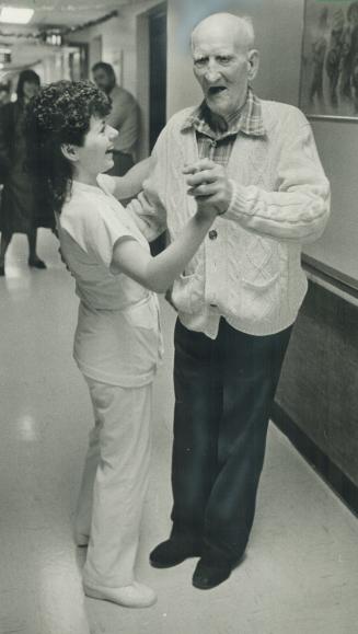 Begin the Beguine: Dave Trumble, Canada's oldest citizen, shows nurse Anita Burke some of the fancy footwork he learned during 116 years of good living