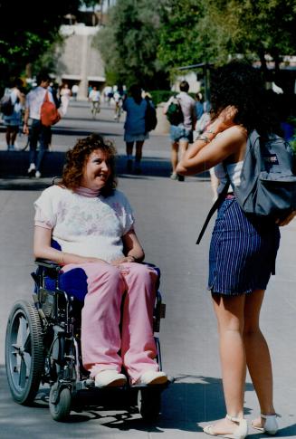 A new start: More than five years after a robber's bullet turned her into a quadriplegic, Barbara Turnbull chats with a friend at an Arizona university