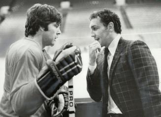 Fraternizing: Leaf defenceman Ian Turnbull (left) stops to chat with former teammate Tiger Williams now a Vancouver Canuck, as their path crossed during practice sessions at the Gardens yesterday