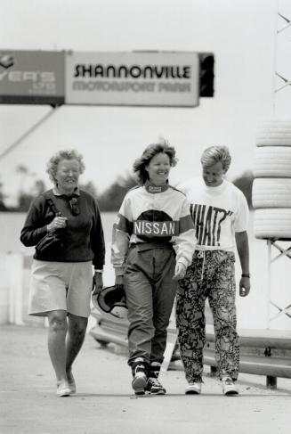 Anne Turner, winner of the Fuji or Wheels Racer for a Day contest, is flanked by her mother, Sadie Walton and husband, Roy, as she heads for a tracksi(...)