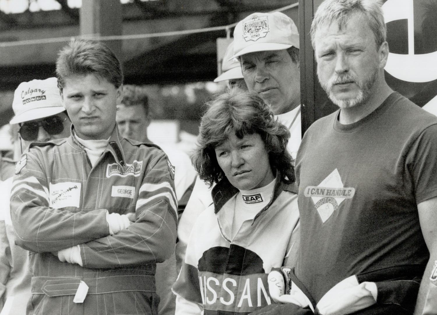 Anne Turner, winner of the Fuji or Wheels Racer for a Day contest, is flanked by her mother, Sadie Walton and husband, Roy, as she heads for a tracksi(...)