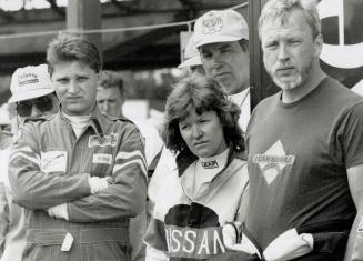 Anne Turner, winner of the Fuji or Wheels Racer for a Day contest, is flanked by her mother, Sadie Walton and husband, Roy, as she heads for a tracksi(...)