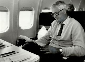 Turner studies the issues aboard his campaign jet, nicknamed 'Derri-Air' after the bum-patting incidents