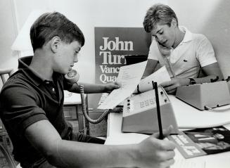 P.M. John Turner sons Andrew, 12 (l) and David, 16 canvassing by telephone on behalf of their father the P.M