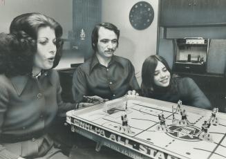 He shoots! He scores! Maple Leaf hockey star Norm Ullman relaxes away from hockey wars with his family in their suburban home in Don Mills
