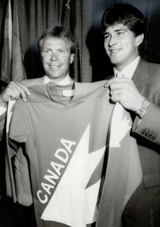 New sweater for Rick: Maple Leaf Rick Vaive, right, holds up the Team Canada sweater with Glen Sather, the mastermind of the squad that will take on the Soviets and Czechs in the Canada Cup