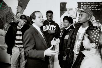 Young critics: Employment Minister Bernard Valcourt finds west Toronto Collegiate students, including Wayne Thomas, wearing glasses, and Richard Anderson, second from right, a tough audience