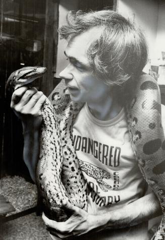 Nioka, a 13-ft. green anaconda that eventually will grow to 300 pounds, studies Bill Valliere, who runs the sanctuary