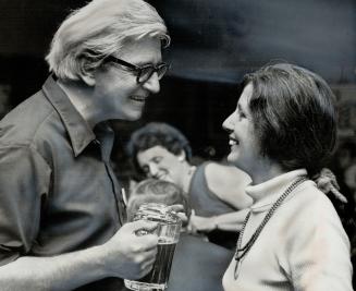 Toasting the victory, architect Colin Vaughan, the mastermind of the Spadina Review Corporation, hoists a stein of beer with his wife, Annette, last n(...)