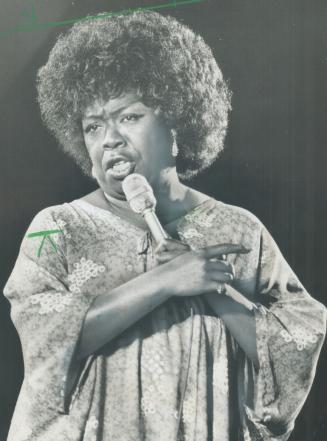 The Divine One,' Sarah Vaughan last night came across like a Super Sunny Earth Momma of Jazz, says The Star's Frank Rasky of concert in the Forum at O(...)