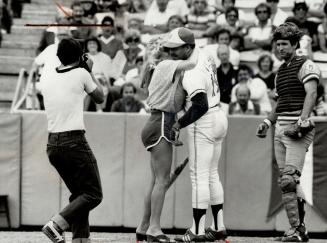 Morganna, a buxon stripper who has made headlines by sneaking into ball parks and kissing major league players, caught a startled Otto Velez of the Bl(...)