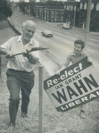 A post to influence the polls. Ian Wahn, Liberal MP for Toronto St. Paul's, gets help from his son Ian Jr., 21, in erecting a sign to remind voters in(...)