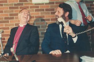 Archbishop of Canterbury Robert Runcie (left) had just been asked a question about Anglican church unity with the Vatican when a telephone rang. Angli(...)
