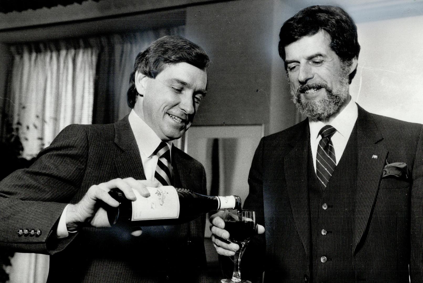 A toast: Ontario Industry Minister Gordon Walker, left, and his Quebec counterpart Rodrigue Biron toast the conclusion of closed-door talks on trade issues yesterday with - what else? - Ontario wine