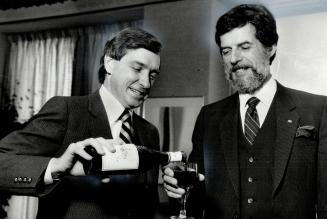 A toast: Ontario Industry Minister Gordon Walker, left, and his Quebec counterpart Rodrigue Biron toast the conclusion of closed-door talks on trade issues yesterday with - what else? - Ontario wine