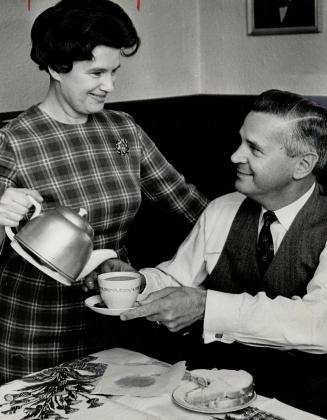 Mrs. Tom Wardle serves tea. Husband, Tom, gets a minute to relax during campaign