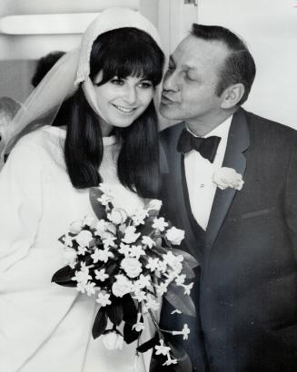 TV Star Frank Shuster kisses his daughter, Rosalind, last night after her marriage at Holy Blossom Temple to Lorne Michaels. The bride interviews perf(...)