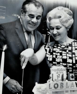 Mr. And Mrs. Leon Weinstein cut cake. It celebrates his first year as president of Loblaws