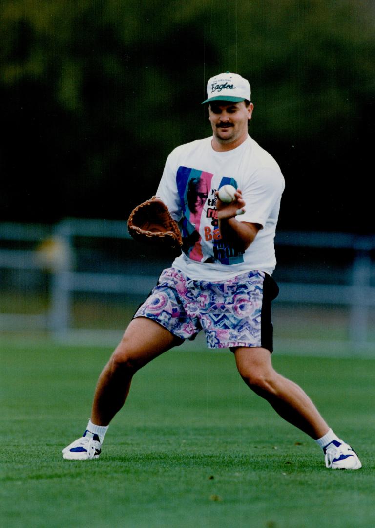Not a fashion plate but a new father, reliever David Wells, held forth at camp on the best way to burp a baby