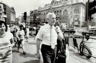 New tasks for veteran politicians: Tom Wells, top picture, walks toward Picadilly Circus on his way to Ontario House on Charles II St
