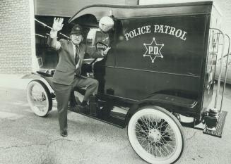 Police patrol-1913 style. Police Commissioner Clare Westcott tries out the commission's latest acquisition-a 1913 Ford paddy wagon. In original condit(...)