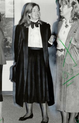 Above, Hilary Weston, wife of supermarket tycoon Galen Weston, wears a feminine version of the menswear look with a foppish artist's bow, white silk blouse
