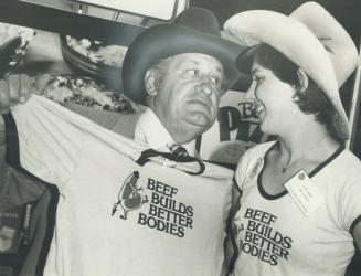 And that's no bull! Federal Agriculture Minister Eugene Whelan displays the beef T-shirt he got from Beth Gehring at the Ex's beef information centre.(...)