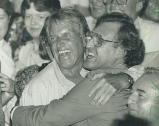 Happy day for Labor: A jubiliant Canadian Auto Workers chief Bob White hugs former NDP leader Stephen Lewis at Bob Rae's victory party Thursday