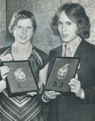 Ontario's finest. High jumper Julie White and Tom Lobsinger, 1,500-metre runner, show off the awards they won as top age-class athletes at annual awar(...)