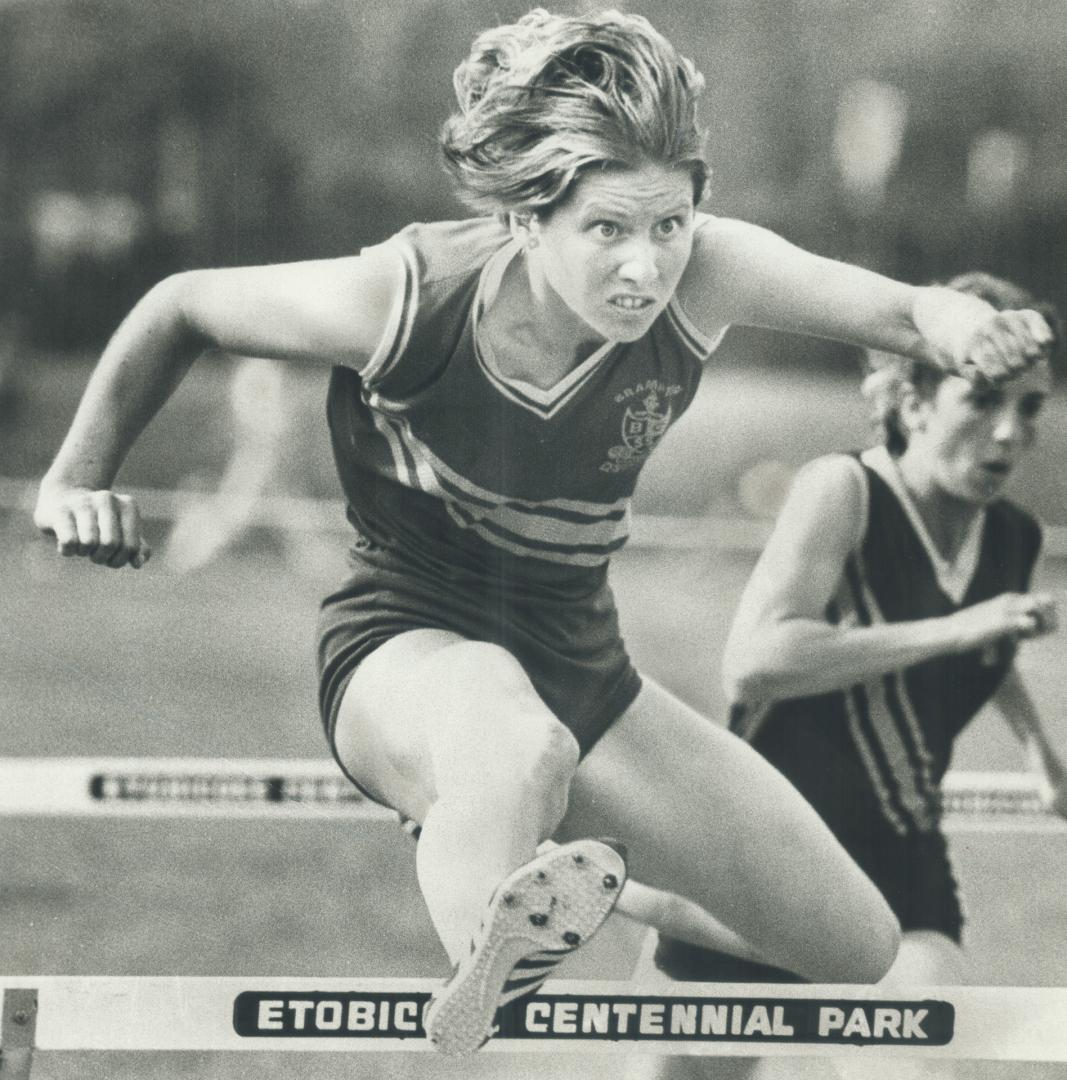 The winner Julie White, 19, of Brampton Centennial Secondary School, a member of Canada's 1976 Olympic team, leaps high during her winnings 14.85-seco(...)
