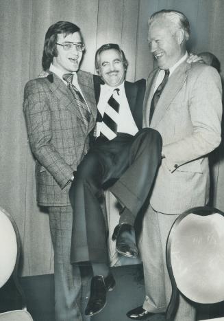 Honored at a dinner for his 15 years as a public servant, York Mayor Philip White is carried by Metro Chairman Paul Godfrey (left) and East York Mayor Willis Blair