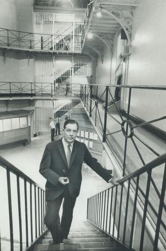 Toronto Jail Superintendent Gerald Whitehead stands on iron stairs in the jail located in central Toronto