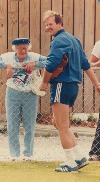 Hello to a fan: Peggy Visser has come south from Toronto's Parkdale district to see the Blue Jays in action, and here she says hello to catcher Ernie Whitt, who's dressed for Florida