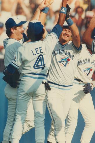 Hero's welcome: Teammates, including Manny Lee (4), give Ernie Whitt high-five greetings as he crosses the plate after hitting home run in 11th inning that defeated the Rangers