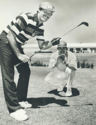 Catcher Ernie Whitt (bunting) and pitcher Dave Stieb, in a catching stance, clown for the camera during the Ernie Whitt charity golf tournament yesterday at Richmond Hill golf club