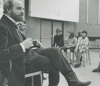 Chris Wiggins leans forward to hear hard-headed question from audience