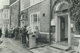 Visitors queue quietly outside the Sinclair and Wight clinic awaiting the author's appearance