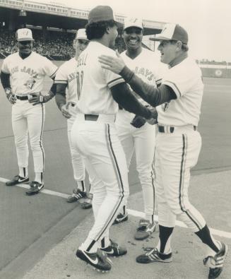 Friends? It's a decidedly happier set of Jays this time around, as skipper Jimy Williams welcomes George Bell with Lloyd Moseby, middle, joining in before the home opener