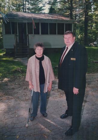 Artist's sanctuary: Elizabeth Fraser Williamson, with Ward 7 representative Fred Johnson, stands outside the cabin where she's lived since the '70s