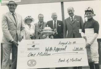 Million-Dollar win: Trainer Roger Attfield, left, jockey Don Seymour and owner Bud Willmot, second from right, accept the $1 million bonus cheque for triple Crown victory