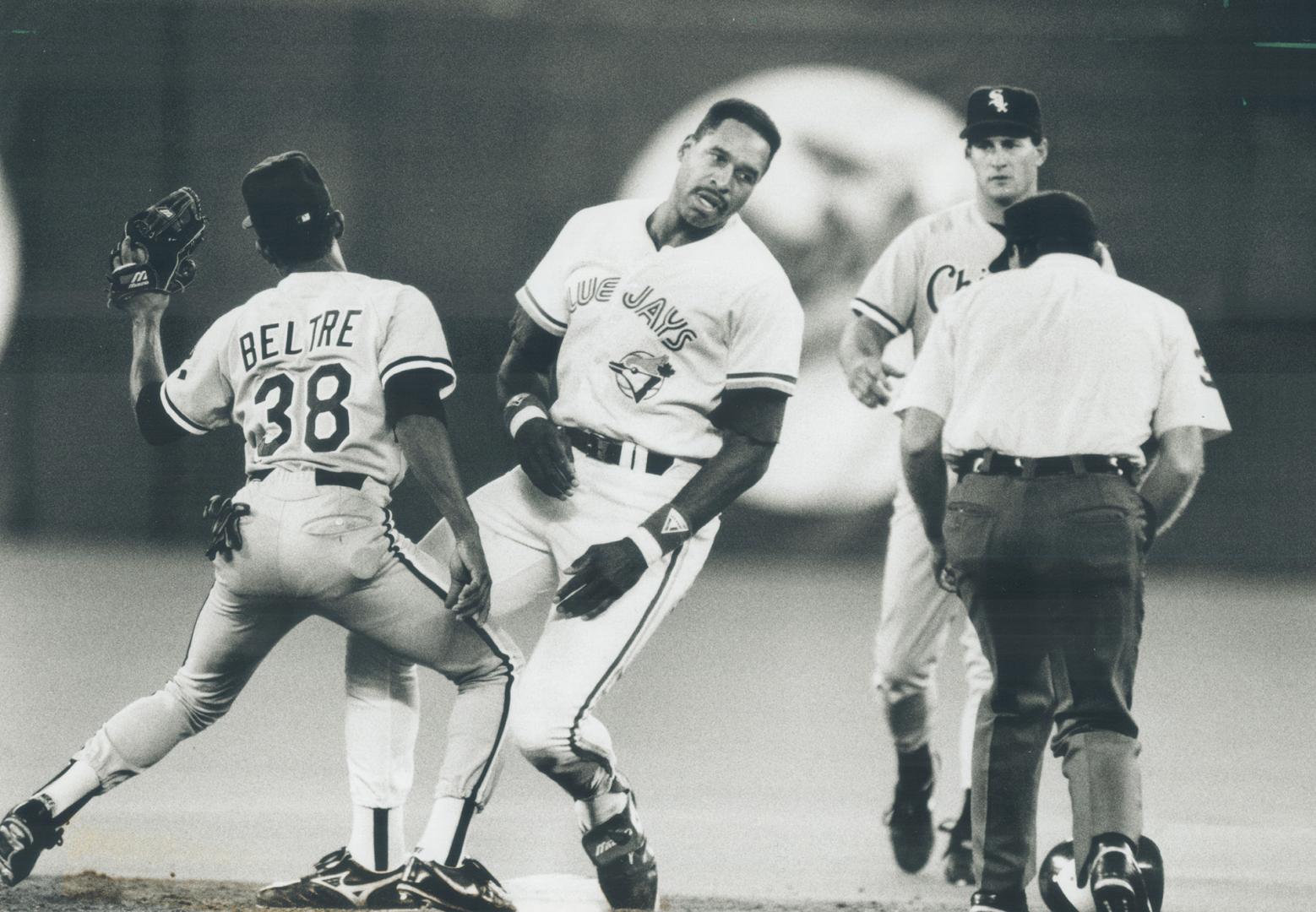 Facing the music: Jays runner Dave Winfield shows his frustration as he's greeted by Esteban Beltre after being thrown out at second in the fourth Inning