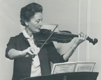 Mrs. Robert Winters plays violin. The entire family is musical - and loves politics