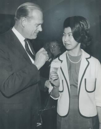 Liberal Tete-A-Tete. Trade Minister Robert Winters takes time out from the Ontario Liberal convention to talk to Margaret Yamanaka of his York West riding. She's a campaign worker