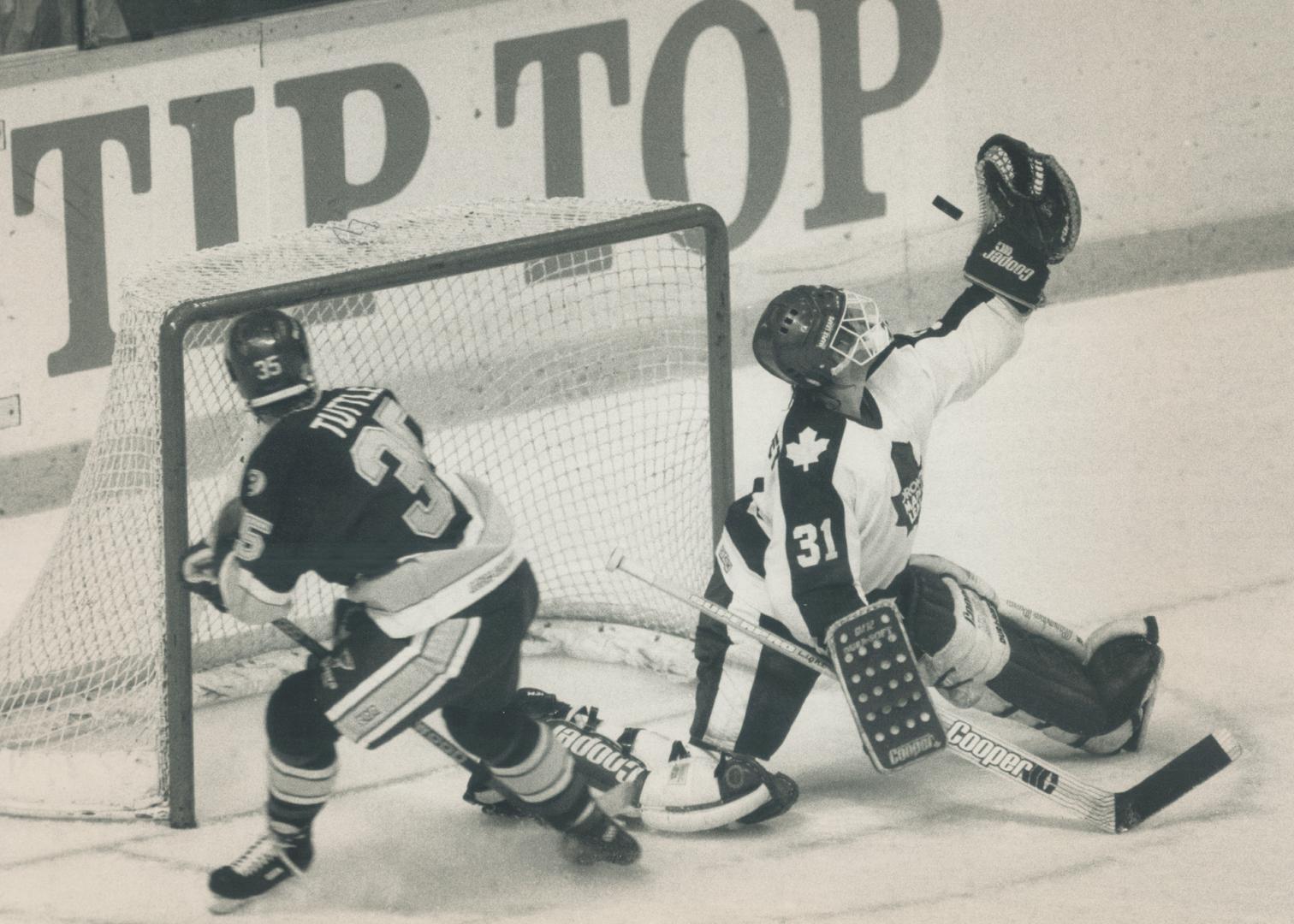 Not this time: Leafs goalie Ken Wregget gets a glove on the puck as Blues winger Steve Tuttle moves into the net during last night's game at the Gardens