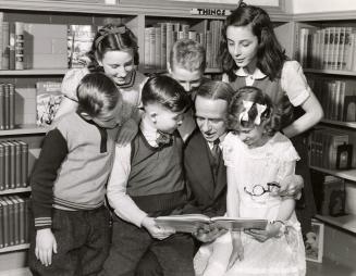 Charles R. Sanderson, Chief Librarian, Toronto Public Library, with children at the opening of East York children's libraries