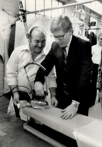 Getting up steam: Ontario New Democratic Party leader Bob Rae, right, gets some tips from presser Jimmy Katsimitsoulias on a tour yesterday of Gordon Dress, a gown-manufacturing plant